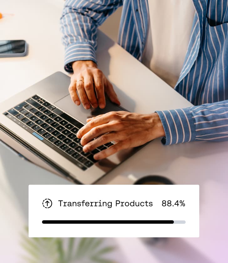 Person typing on a laptop with a data transfer status bar showing 88.4% completed